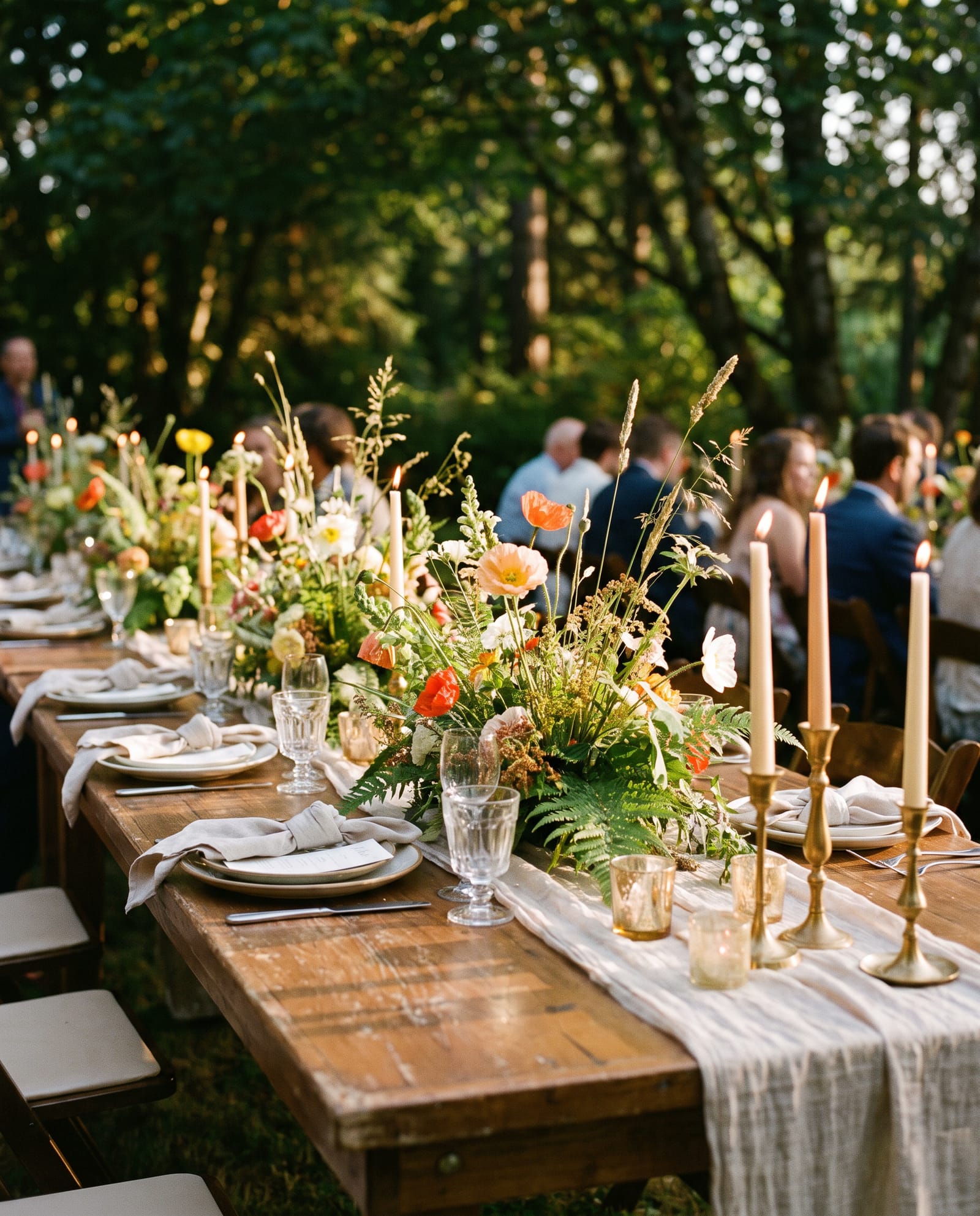 A wild floral installation along a wedding table